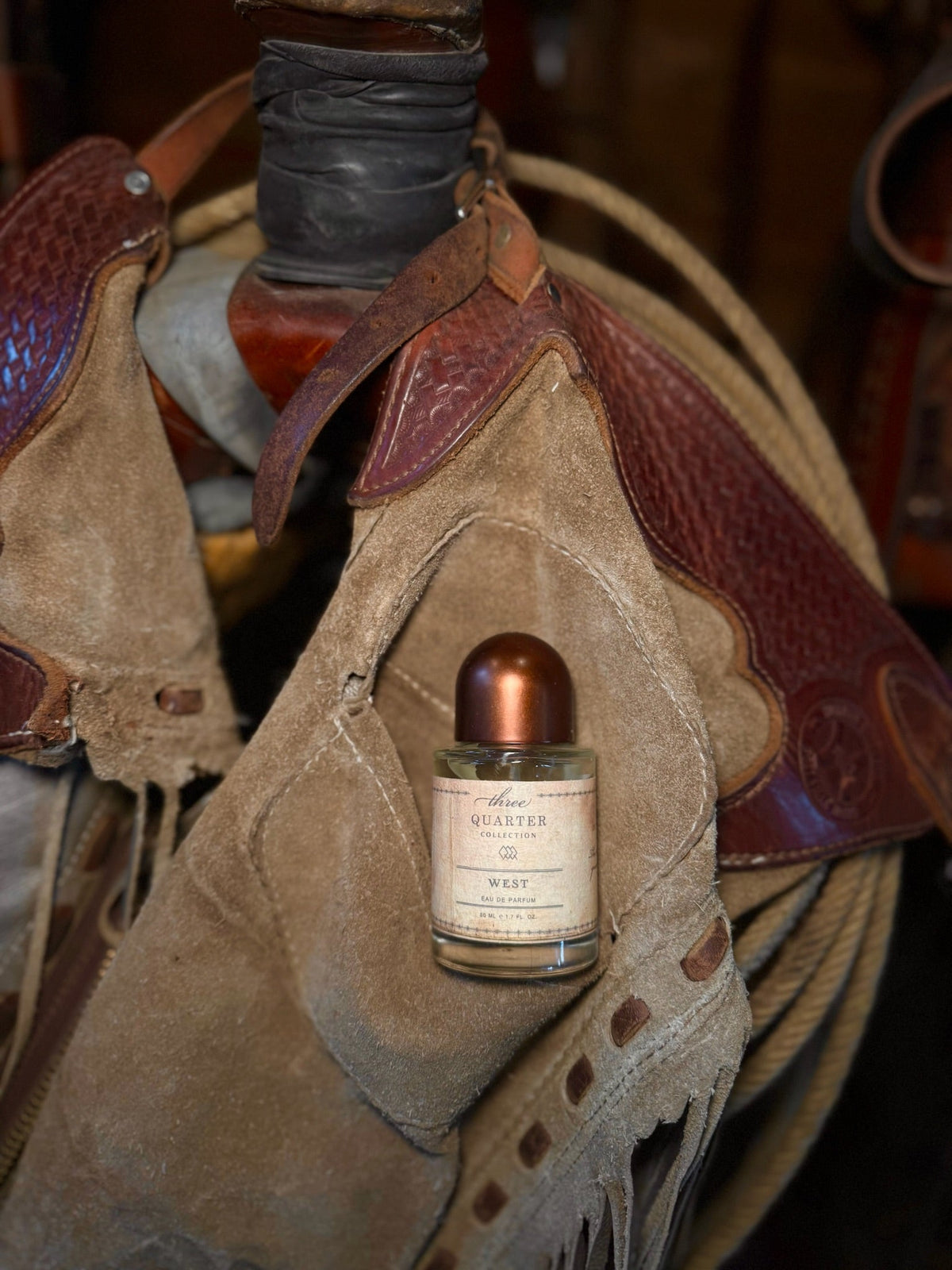 Three Quarter Collection bottle resting on a saddle